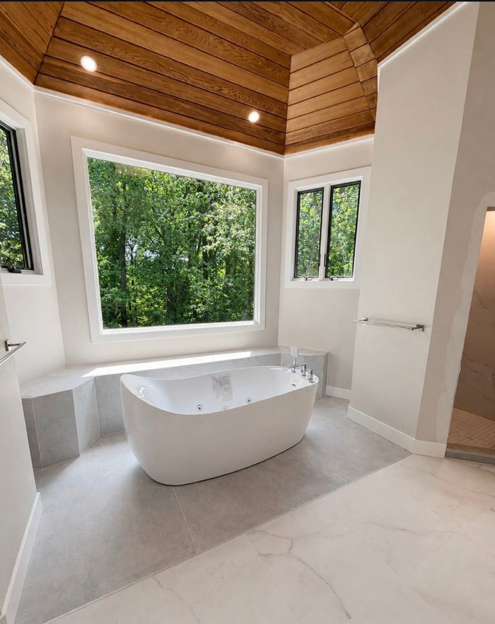 Freestanding soaking tub in a remodeled master bathroom, plumbed by Tucker's Plumbing