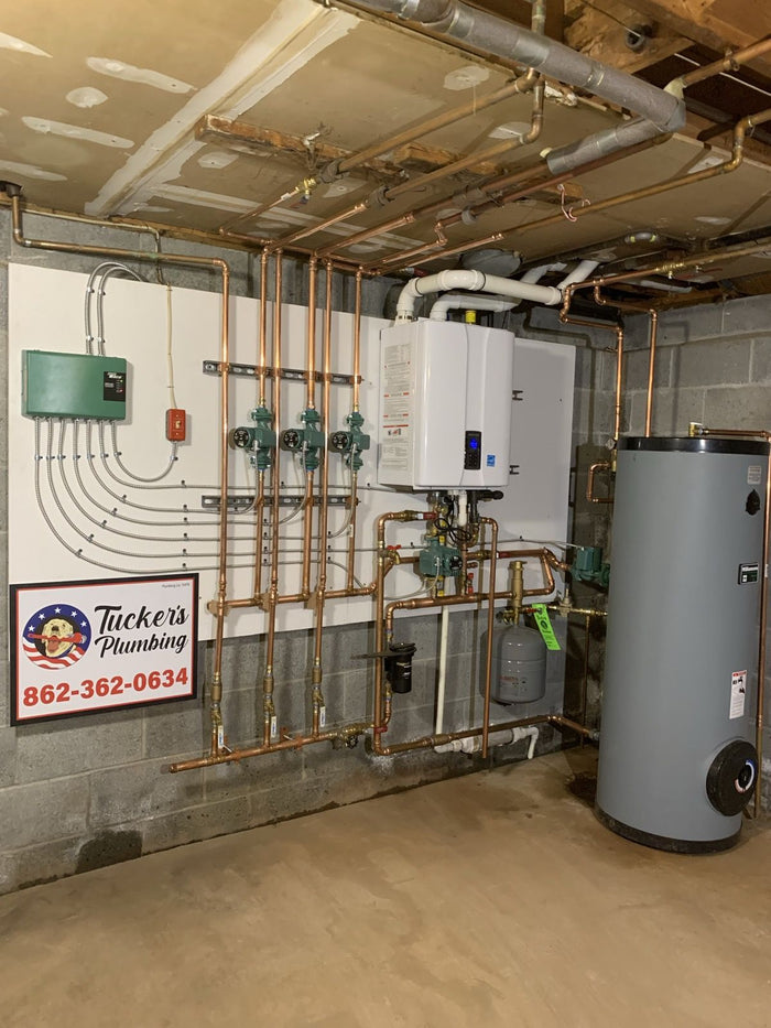 Mechanical room with an indirect water heater and zone piping, installed by Tucker's Plumbing