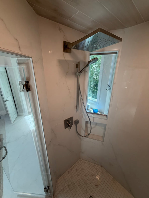 Walk-in shower with rain head and hand shower