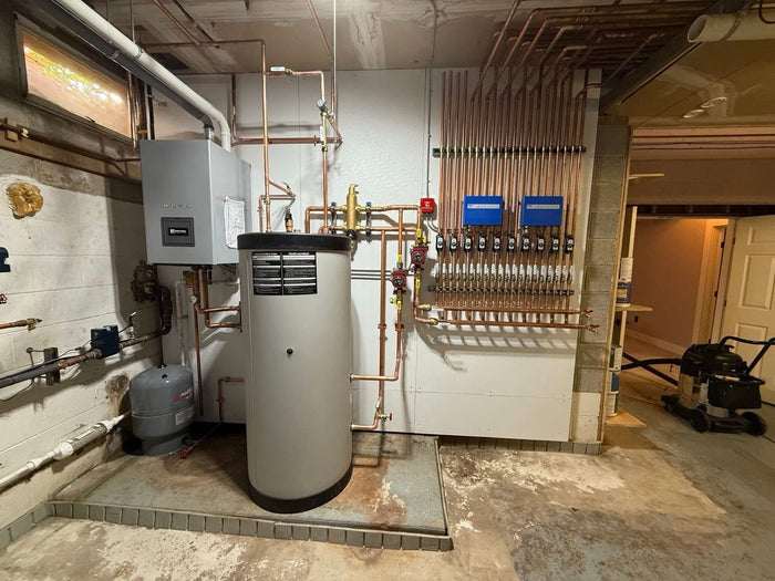 Boiler with indirect water heater and copper zone manifold, installed by Tucker's Plumbing