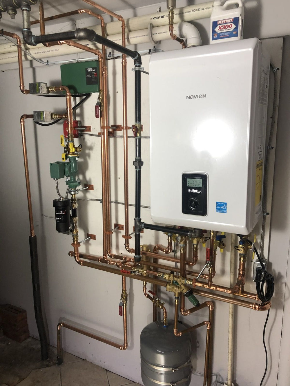 Wall-hung high-efficiency gas combi boiler with copper piping, installed by Tucker's Plumbing