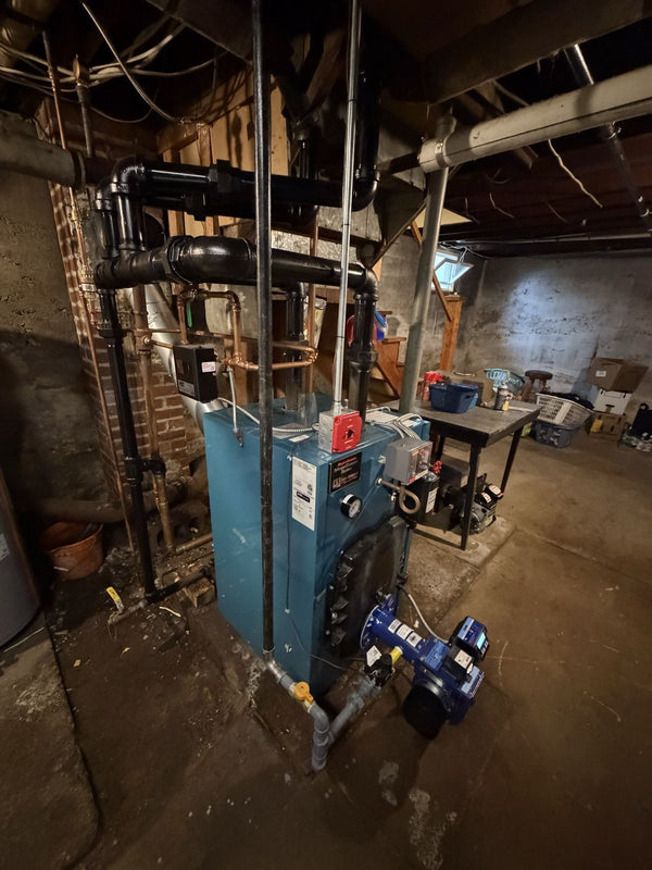 An older cast iron boiler in a Morris County basement
